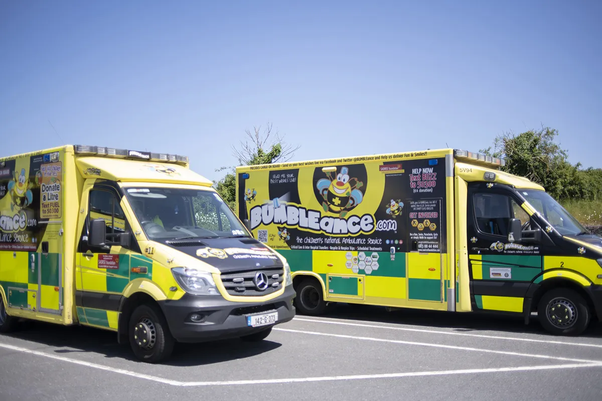 Two brightly coloured BUMBLEance children's ambulances parked side by side